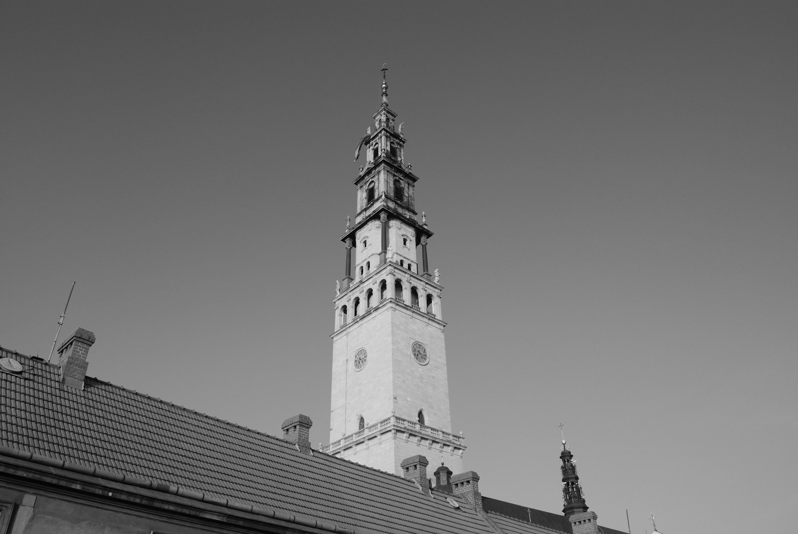 Photo by Arkadiusz Polak a black and white photo of a clock tower