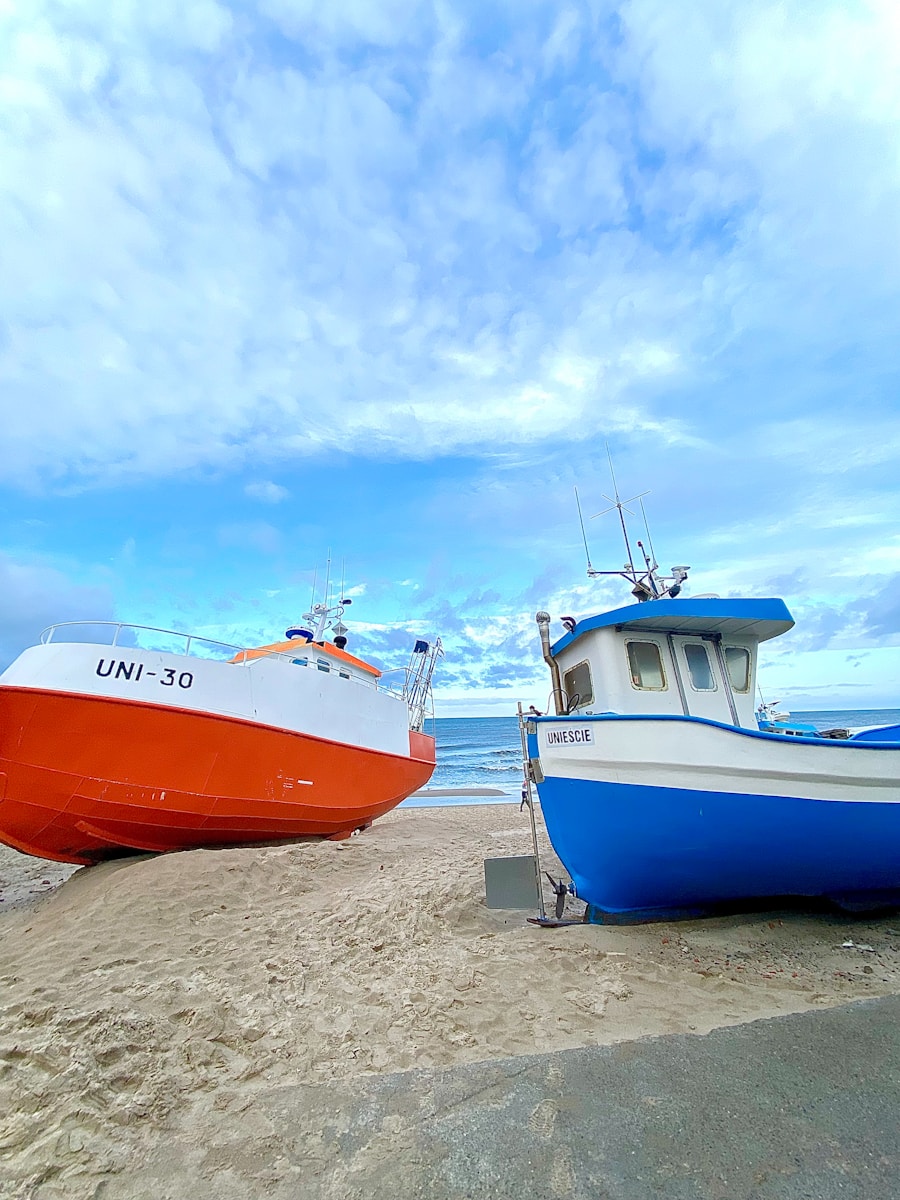 Photo by Bernd Möller two boats sitting on the sand at the beach